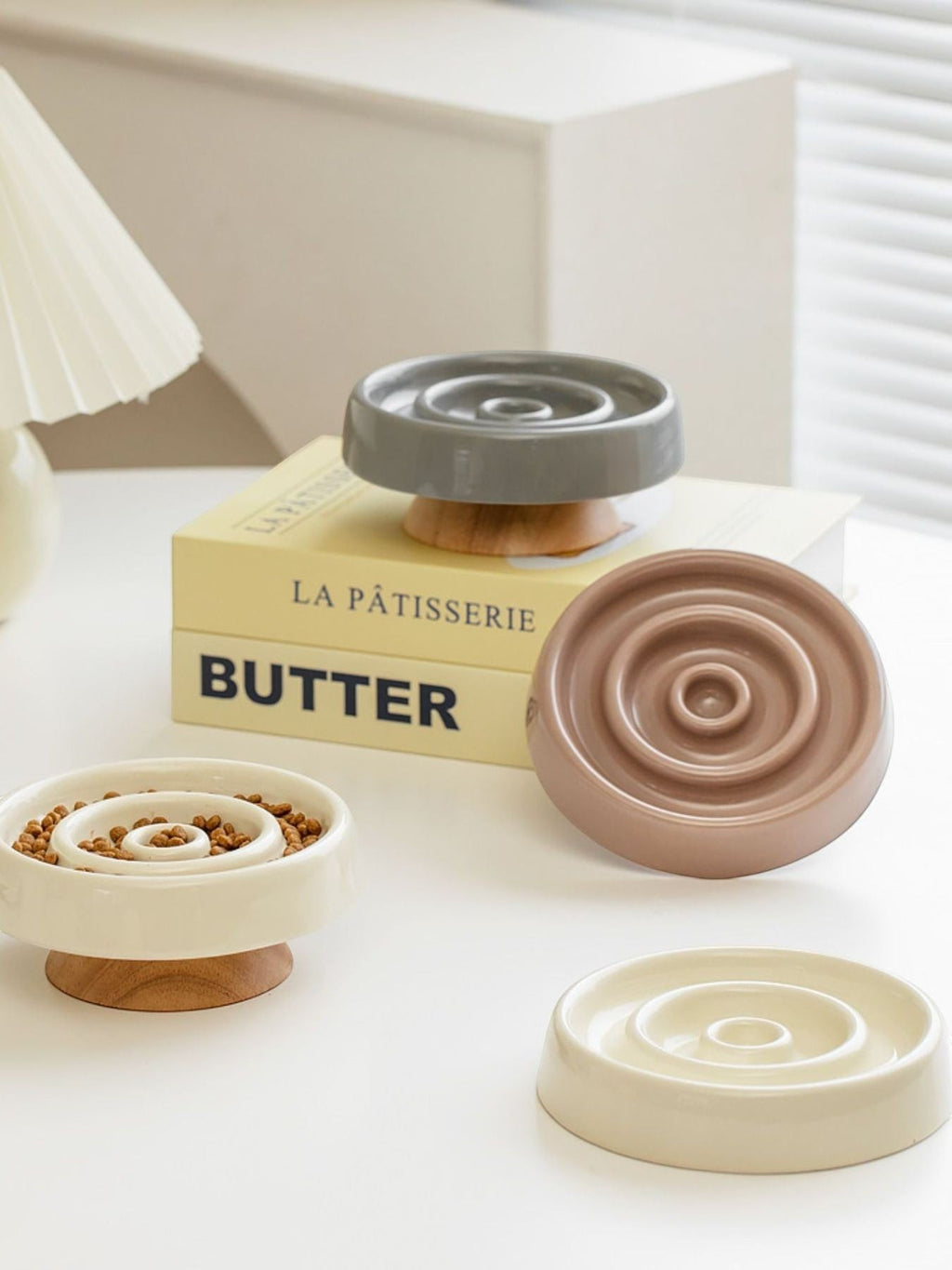 Little Pets Club elevated ceramic slow feeder bowls in cream, grey, and taupe with wooden bases, designed for cats and dogs.