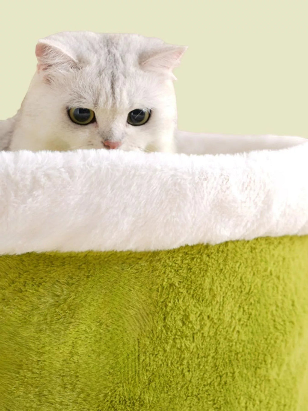 The Cozy Critter Cave™ pet bed from little pets club is a plush, semi-enclosed green hideout with a white fuzzy rim, perfect for cats who love to burrow.