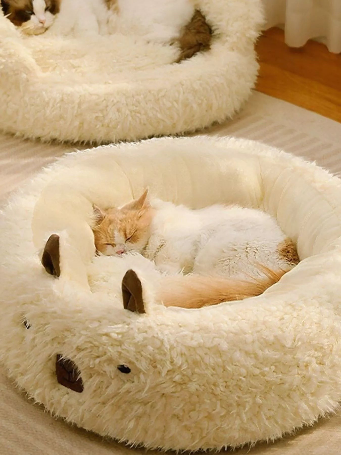 Little Pets Club cream plush bear-shaped pet bed with raised edges and a sleeping cat.