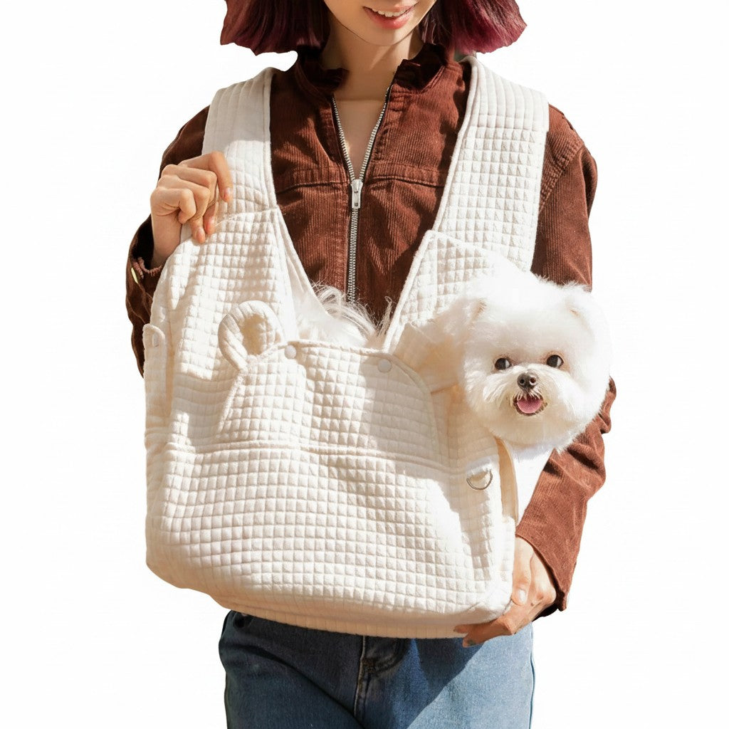 little pets club cream quilted cotton pet carrier sling bag with a small white dog peeking out
