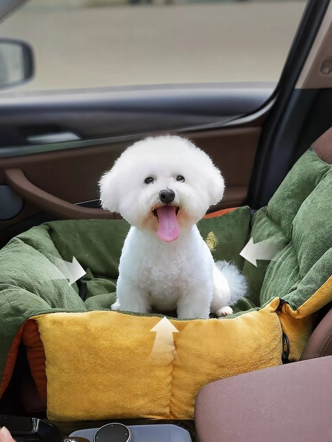 Little Pets Club green and yellow dog car seat bed with a white Bichon Frise dog sitting inside.
