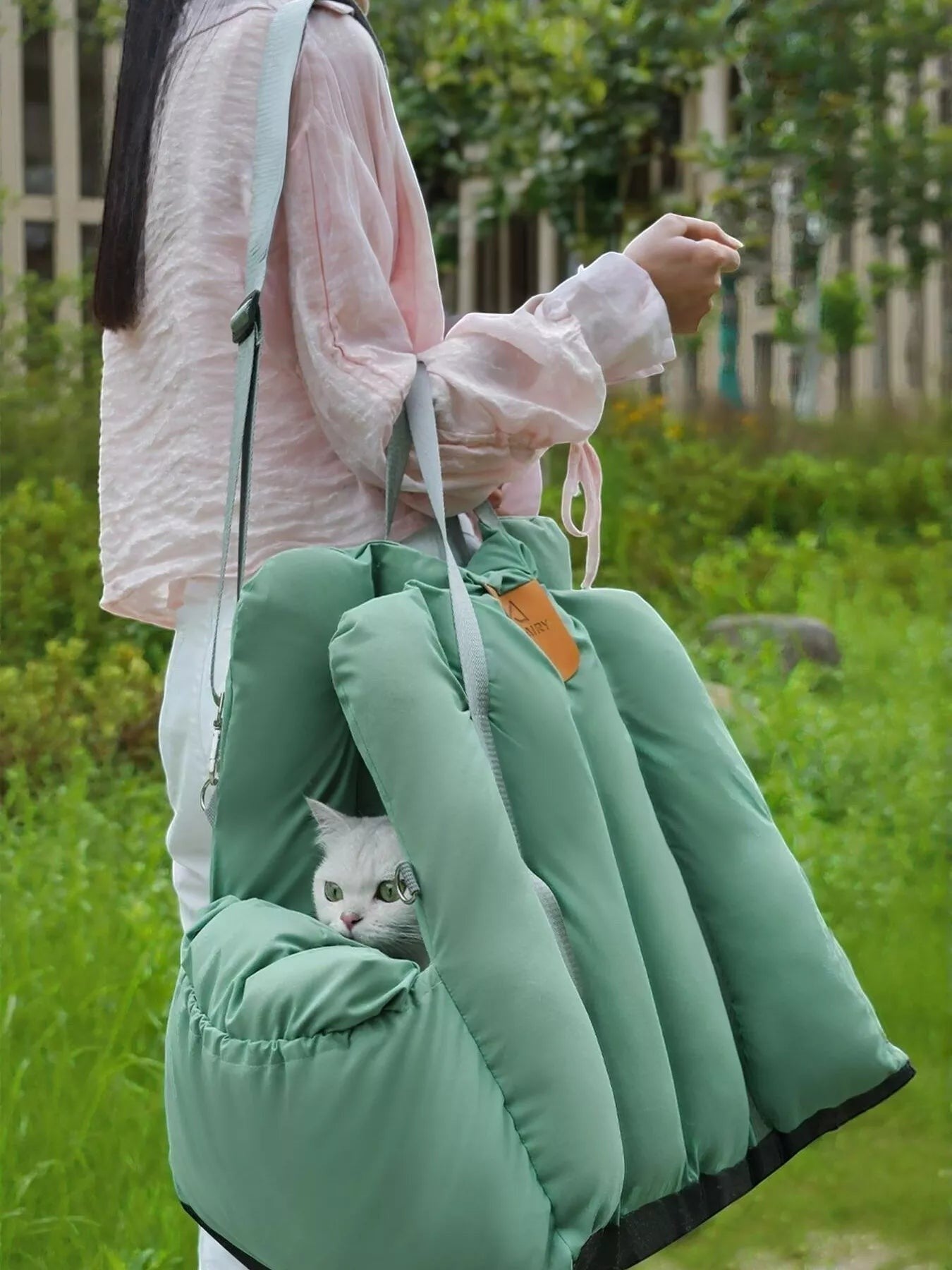 Little Pets Club sage green convertible pet travel tote and car seat carrier with plush interior, holding a white cat.