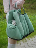 Sage green quilted pet travel tote and car seat carrier by little pets club, with a white cat peeking out.