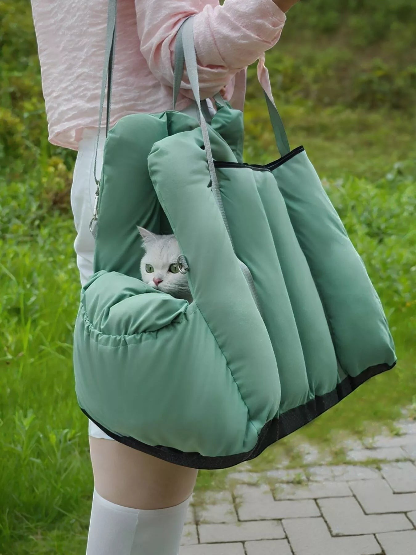 Sage green quilted pet travel tote and car seat carrier by little pets club, with a white cat peeking out.
