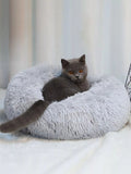 Little Pets Club grey plush donut cat bed with a grey cat resting inside. Features faux fur and raised edges for comfort.