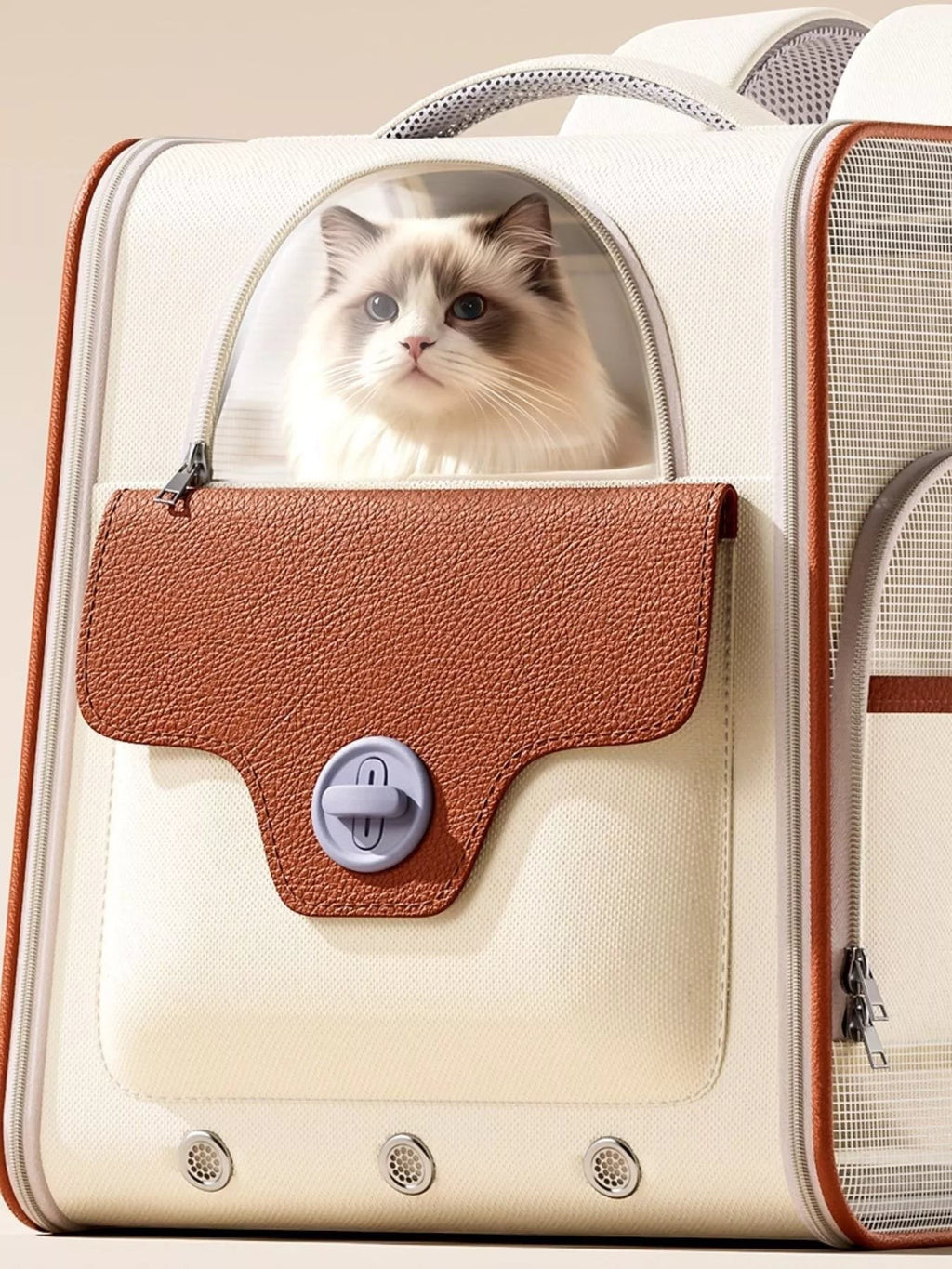 Little Pets Club cream and brown pet carrier backpack with a clear dome window showing a fluffy cat inside. Features a faux leather flap with a twist lock closure.
