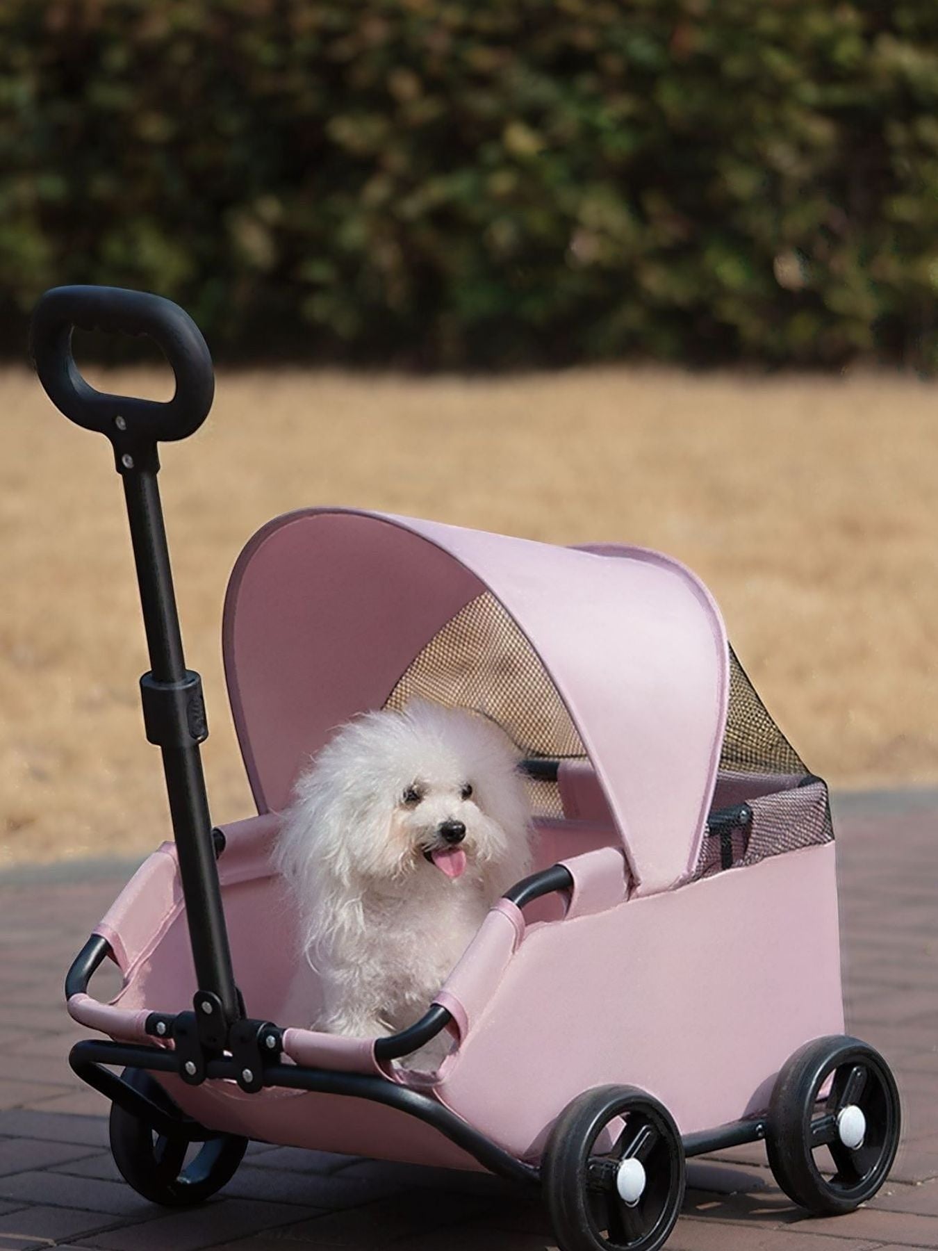 Little Pets Club pink pet stroller with a white Bichon Frise dog inside, featuring a mesh canopy and smooth-rolling wheels.