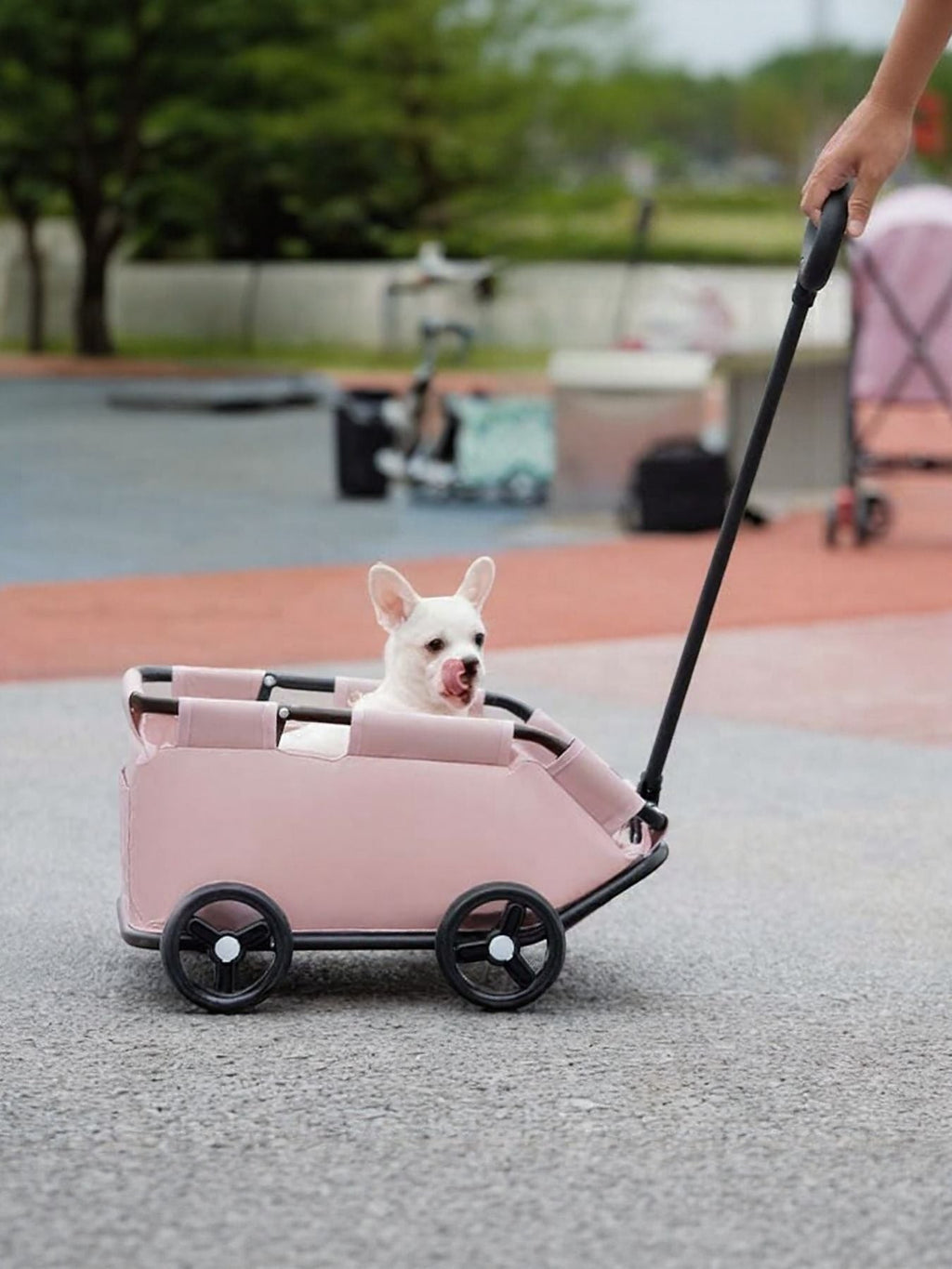 Little Pets Club pink portable pet stroller wagon with a white French bulldog inside. Features smooth-rolling wheels and a comfortable interior.