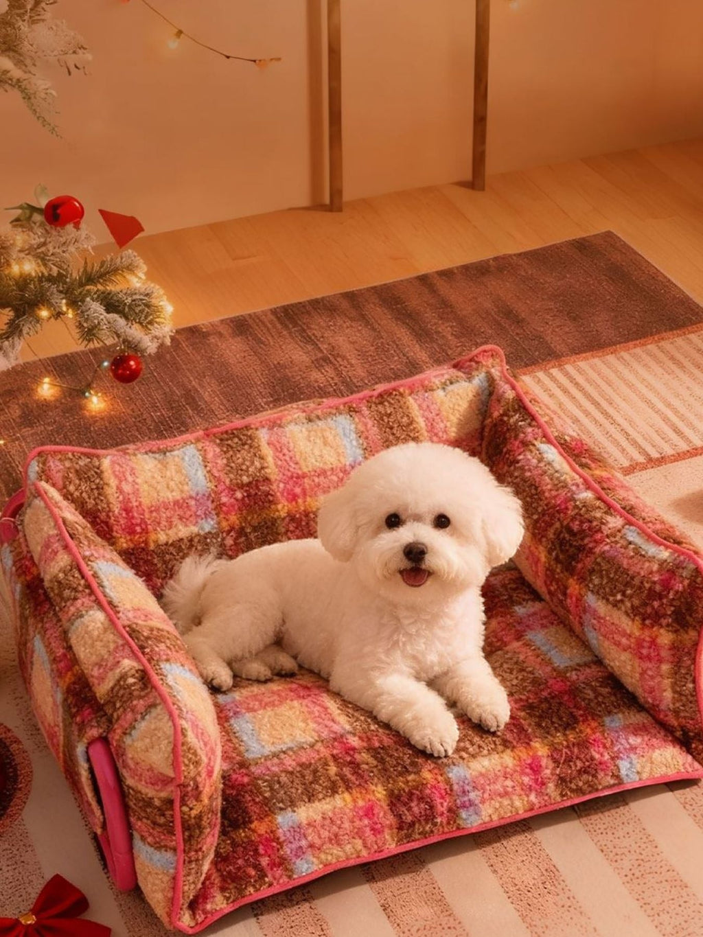 Little Pets Club cozy plaid dog sofa with raised sides and plush fabric. A white Bichon Frise rests on the bed.