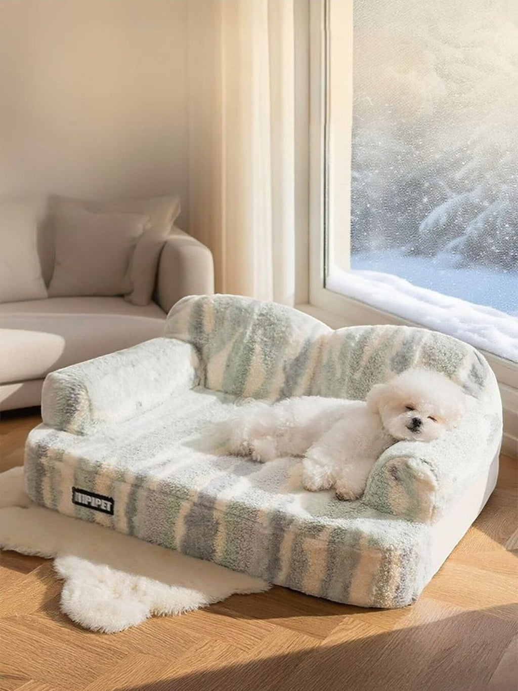 Little Pets Club plush pet sofa bed in green and white stripes with a small white dog sleeping on it.