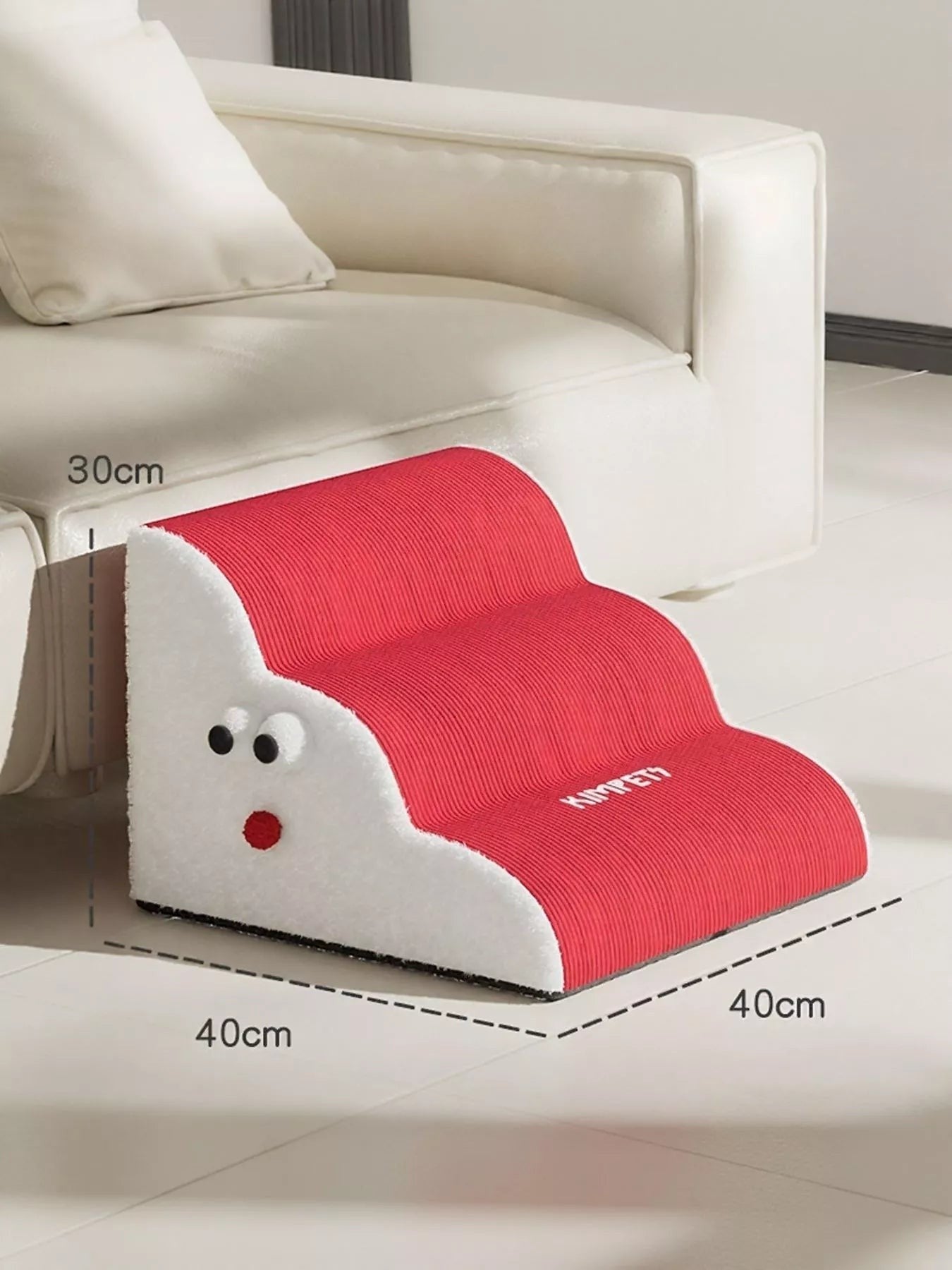 Little Pets Club red 3-step foam pet stairs with white fluffy sides and cute face detail, next to a cream sofa.