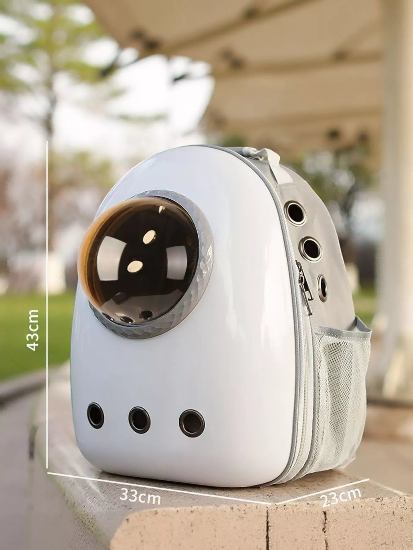 Little Pets Club white and grey space capsule pet carrier backpack with transparent dome and mesh pockets. Measures 16.9" H x 13" L x 9.1" W.