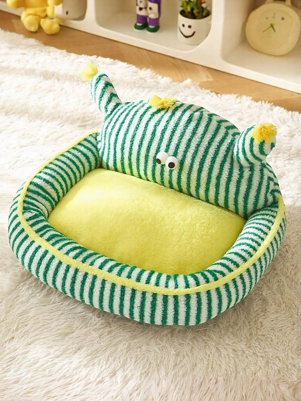 Little Pets Club green and white striped plush pet bed with yellow bolster and googly eyes. Soft calming nest for cats and dogs.