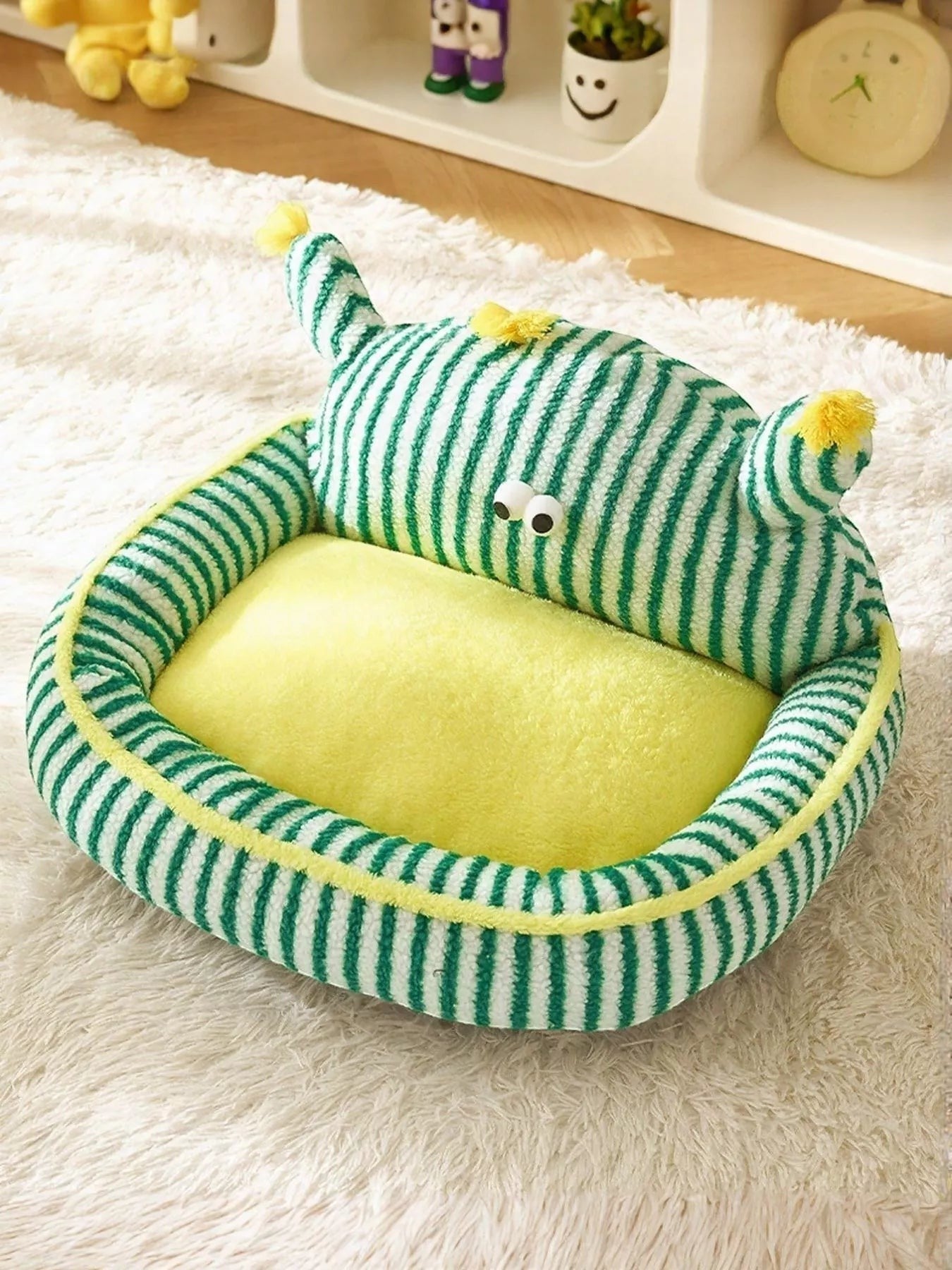 Little Pets Club green and white striped plush pet bed with yellow bolster and googly eyes. Soft calming nest for cats and dogs.