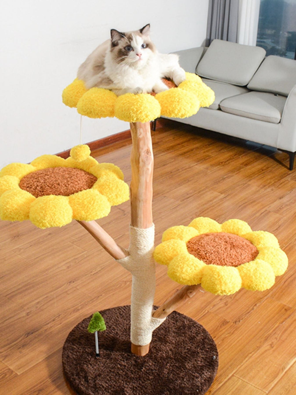 Little Pets Club Sunflower Cat Tree with plush yellow flower perches and sisal scratching posts. A Ragdoll cat rests on the top perch.