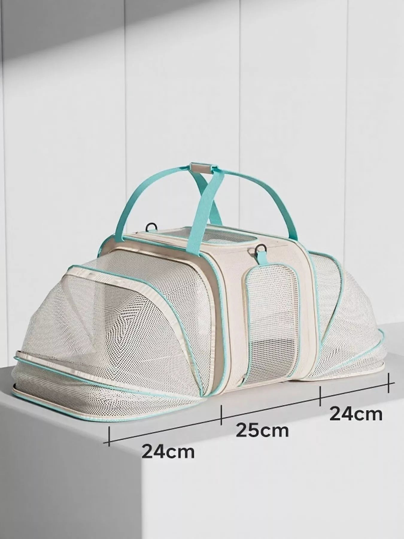 Little Pets Club beige and teal wheeled pet carrier with mesh viewing windows and top handles.
