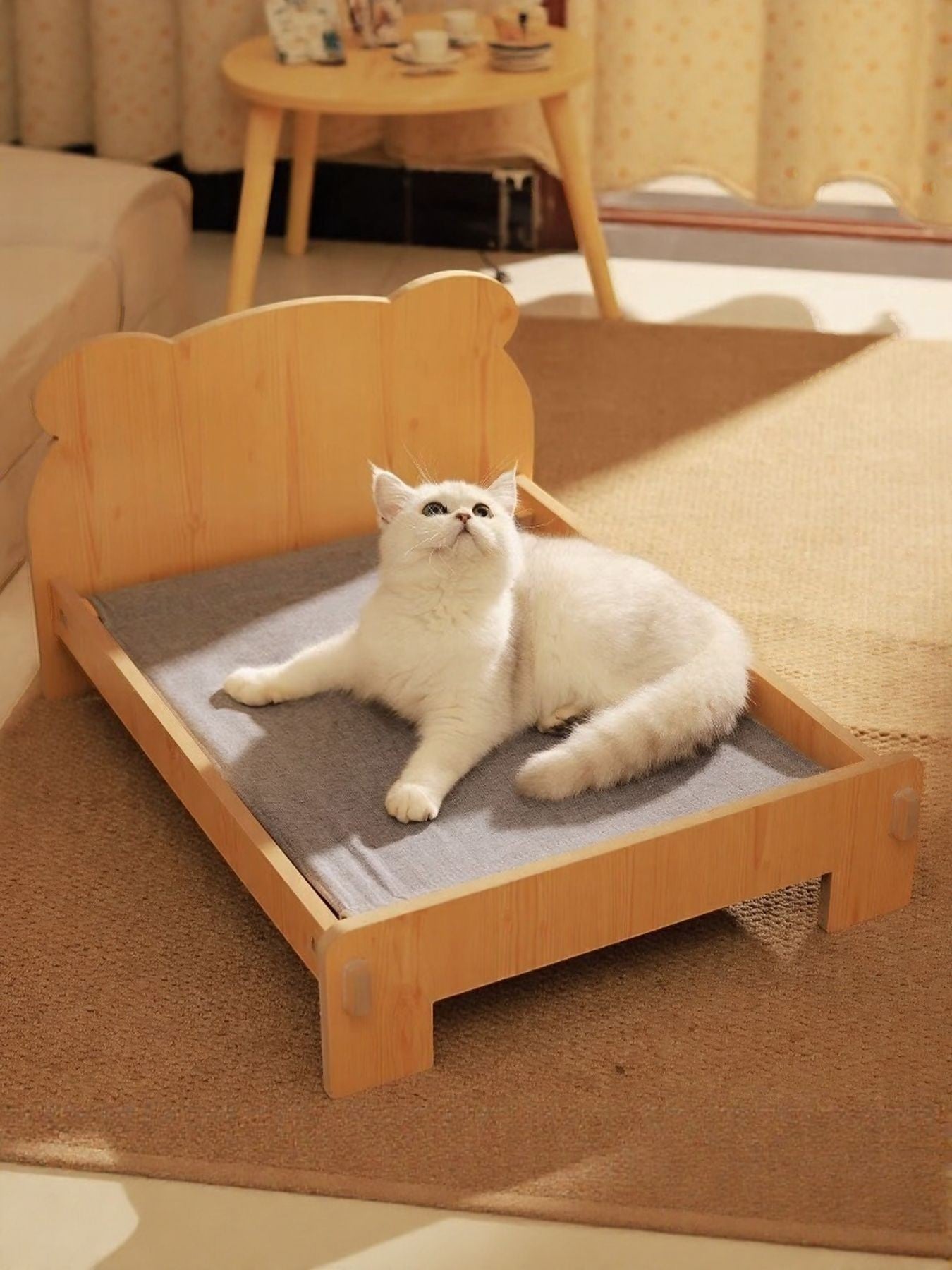 Little Pets Club natural wood pet bed with grey cushion and bear-shaped headboard. A white cat rests on the bed.