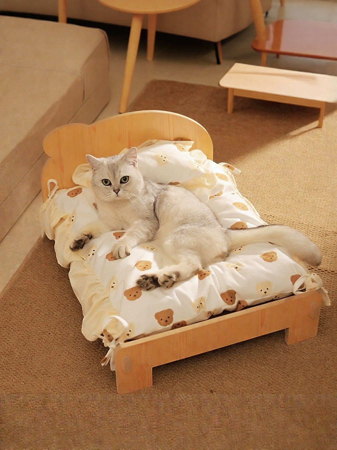 Little Pets Club mini wooden pet bed with a white cushion featuring a teddy bear print. A silver cat rests on the bed.