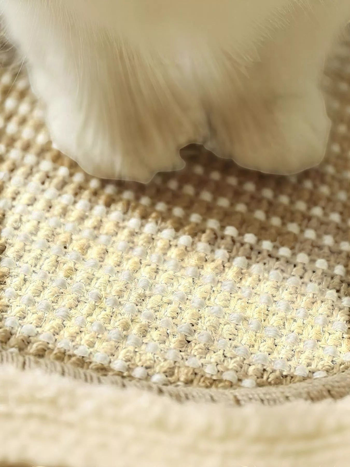 little pets club woven sisal cat lounge bed with a cat's paw resting on it, tan and cream.
