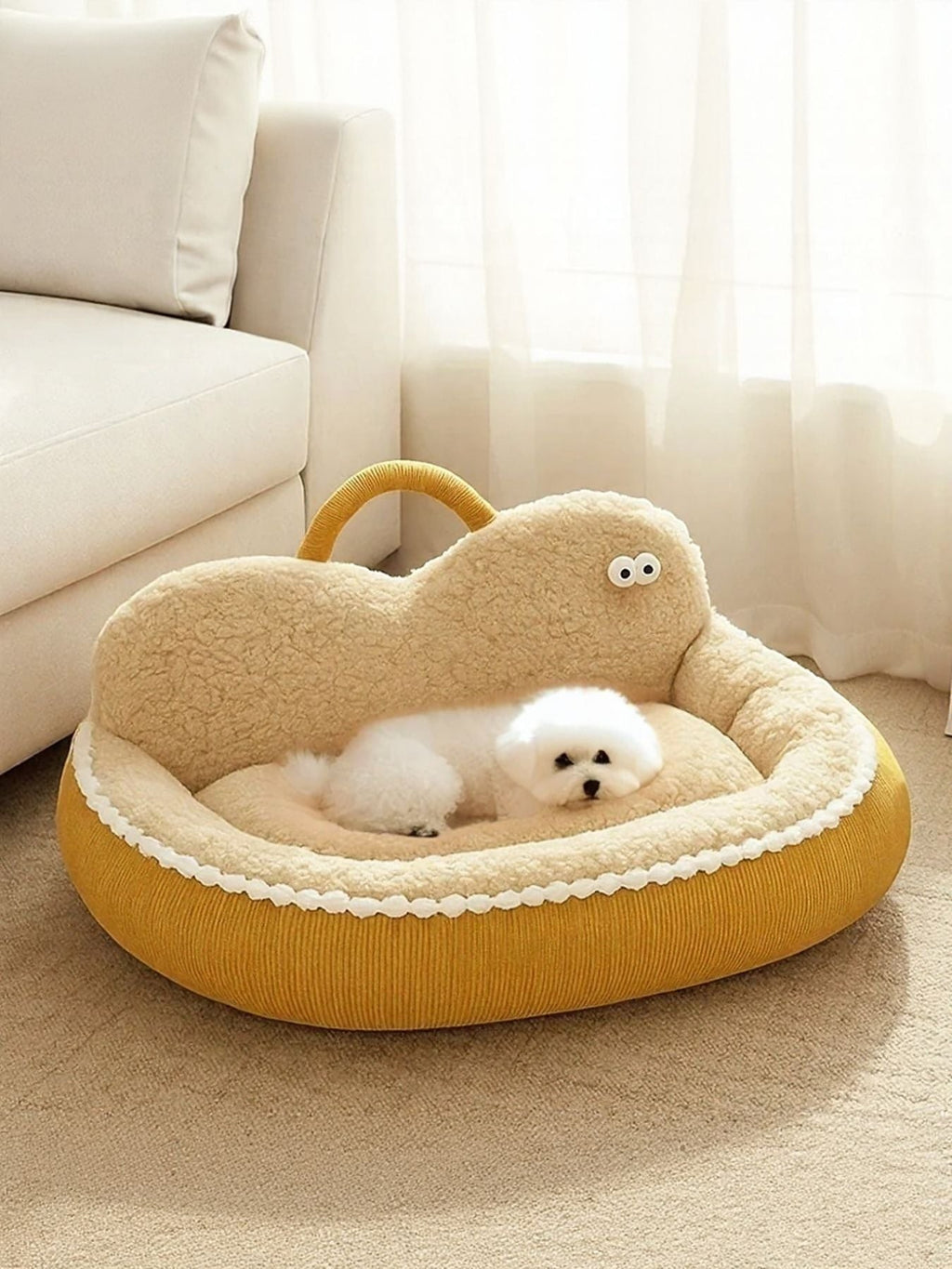 Little Pets Club yellow corduroy orthopedic pet sofa bed with plush lining and raised edges, featuring a cute cartoon face design. A small white dog rests comfortably inside.