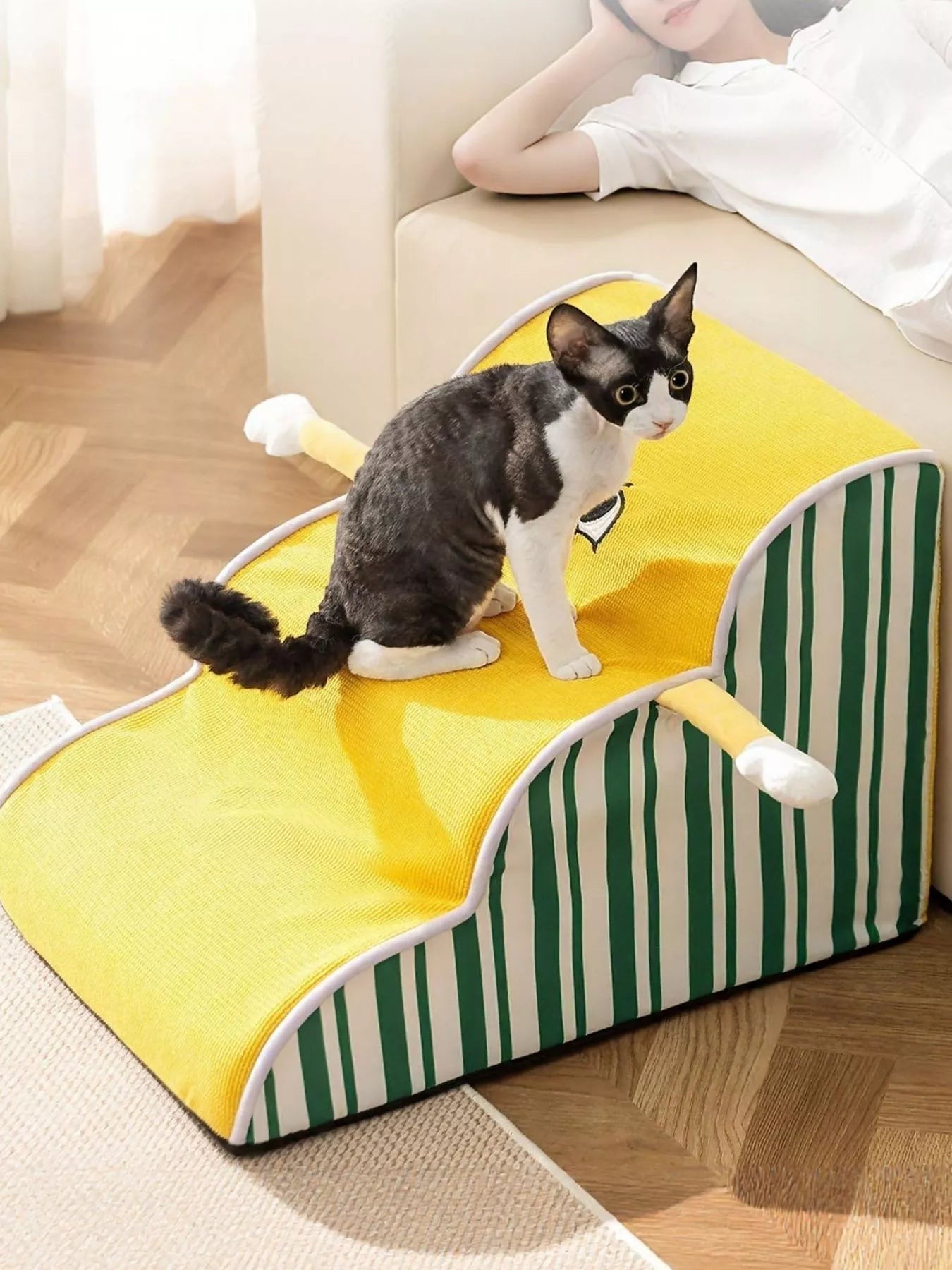 Little Pets Club yellow pet steps with green stripes, featuring a black and white cat. Supports pets reaching furniture.