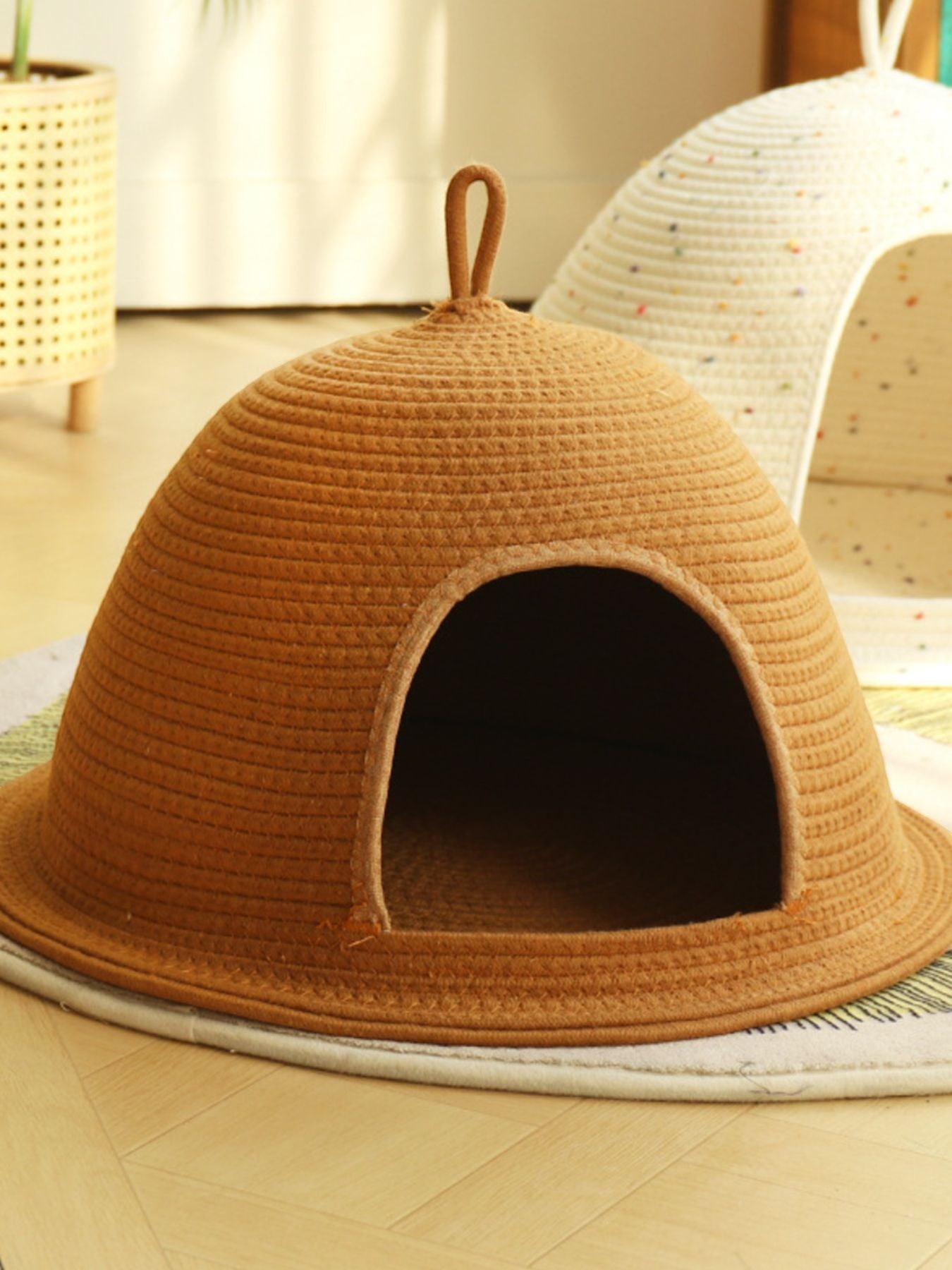 Little Pets Club Cozy Hideaway Cave pet bed in brown woven material with a semi-enclosed design and loop handle.
