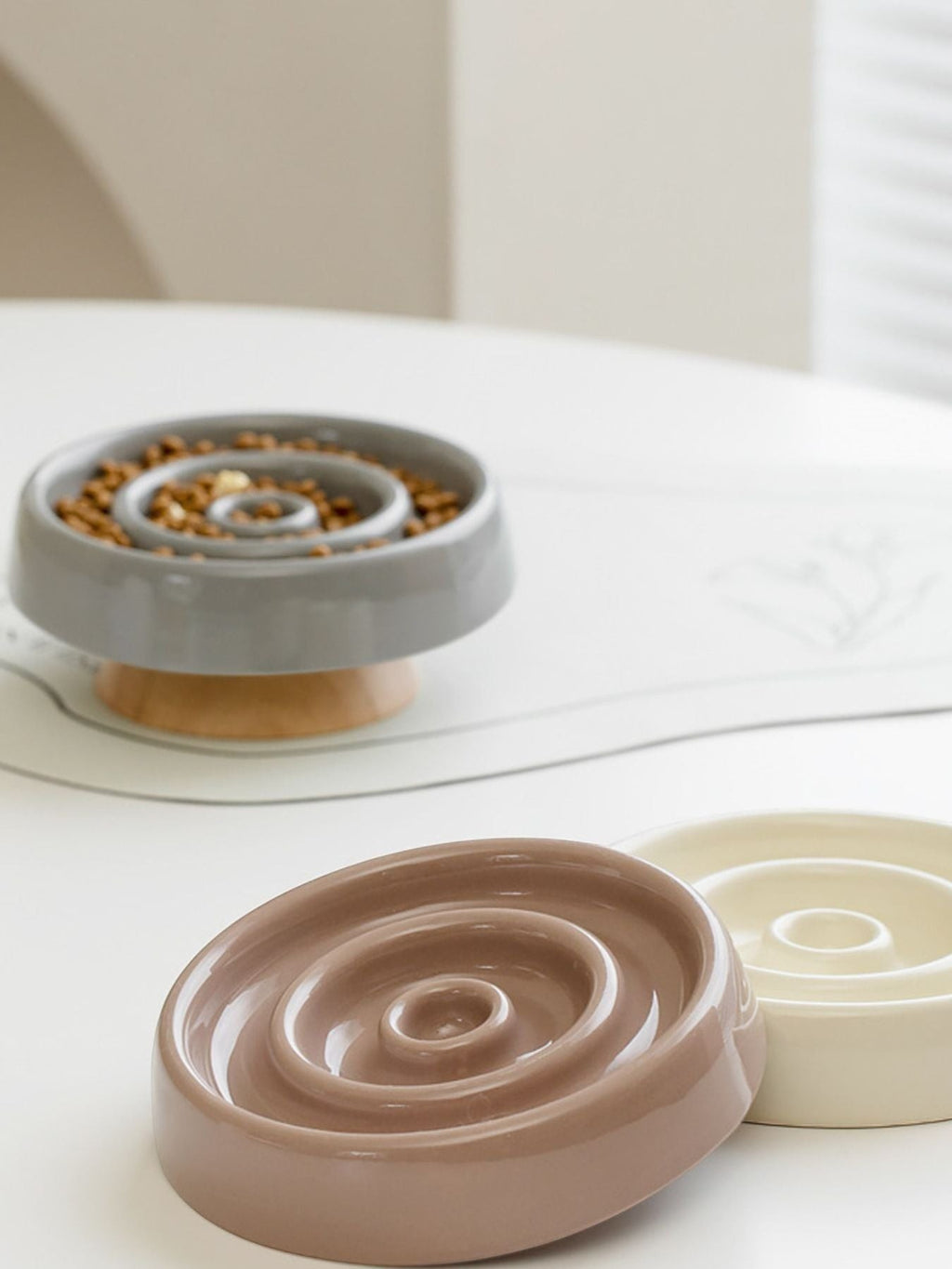 Little Pets Club grey ceramic slow feeder dog and cat bowl with wooden base, also shows brown and cream bowls.