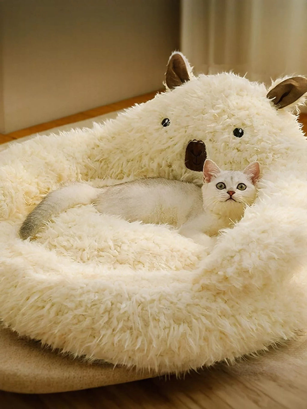Little Pets Club cream plush bear-shaped pet bed with raised edges and a white cat resting inside.