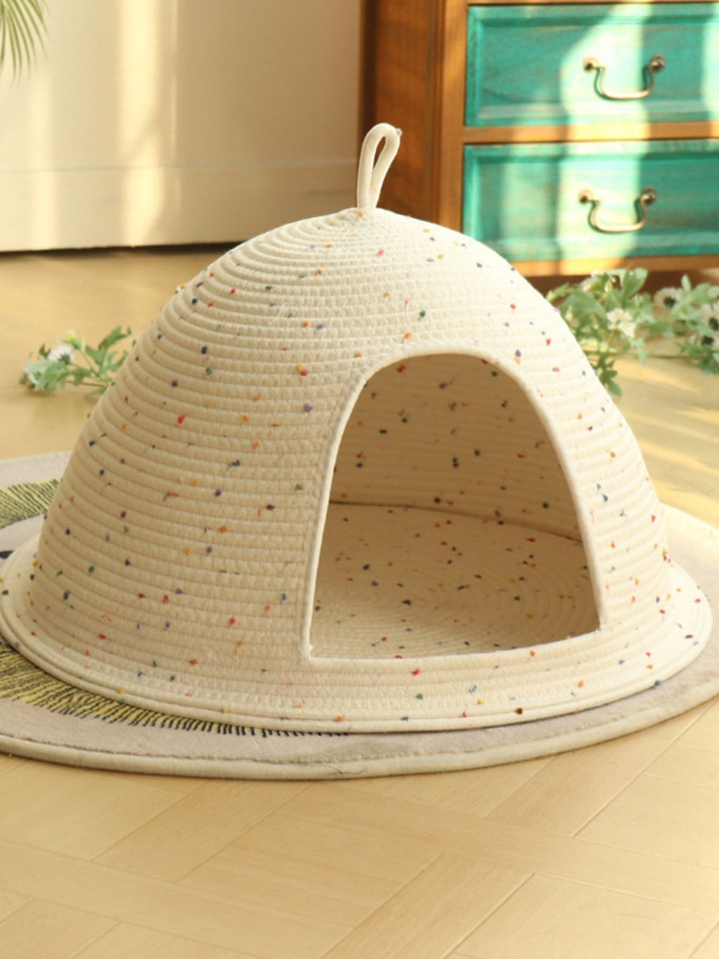 Little Pets Club Cozy Hideaway Cave pet bed, a cream woven dome with colorful speckles and an arched entrance.