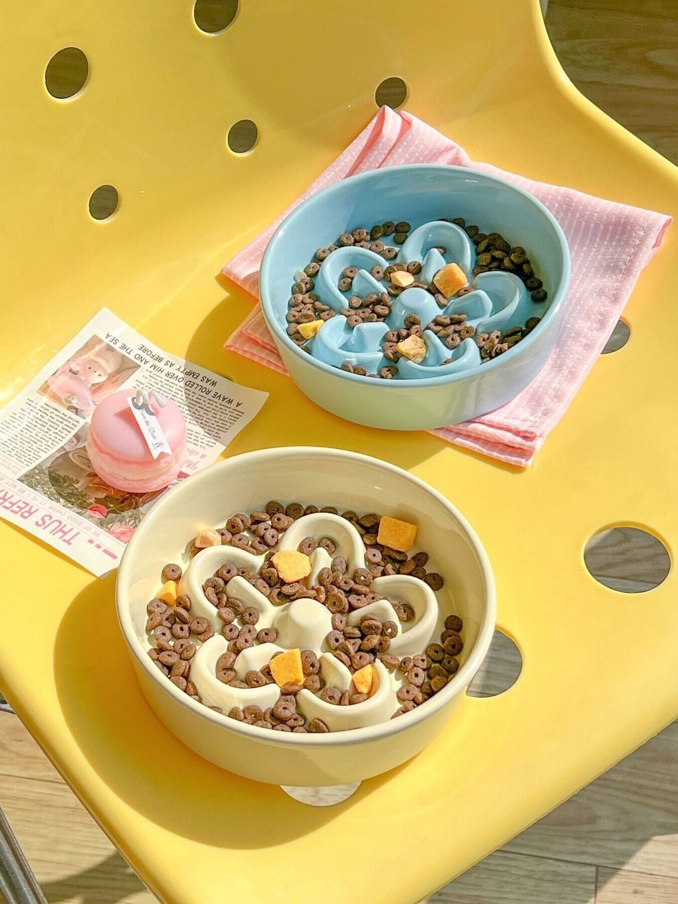 little pets club pastel blue and cream ceramic flower slow feeder pet bowls filled with kibble and treats