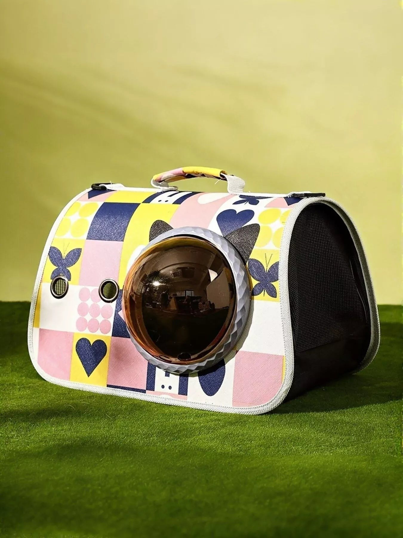 Little Pets Club pet carrier with bubble window, featuring a colorful geometric and heart print. Mesh sides for ventilation.