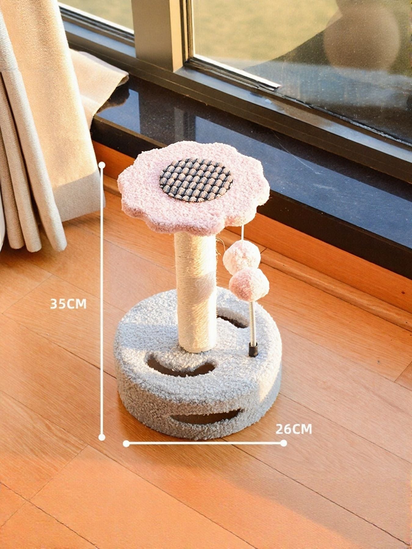 Little Pets Club pink flower cat scratching post with grey plush base and dangling pom balls.
