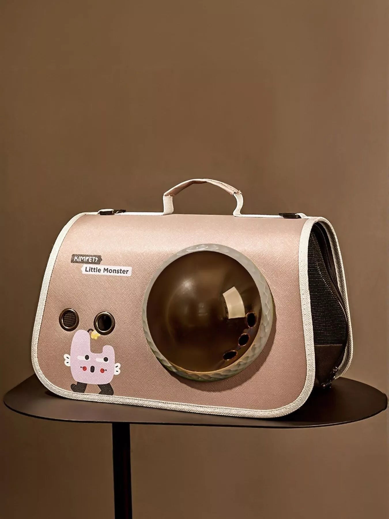 Little Pets Club pink pet carrier with bubble window and cute monster graphic. Features mesh sides for ventilation and a comfortable handle.