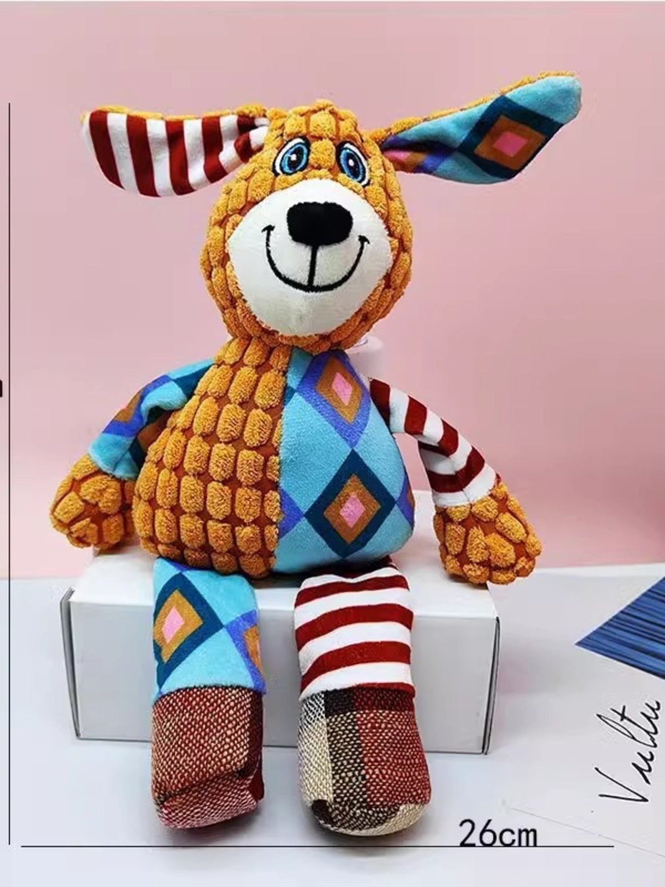 Little Pets Club plush dog toy with orange corduroy body, blue diamond pattern, and striped ears and legs.