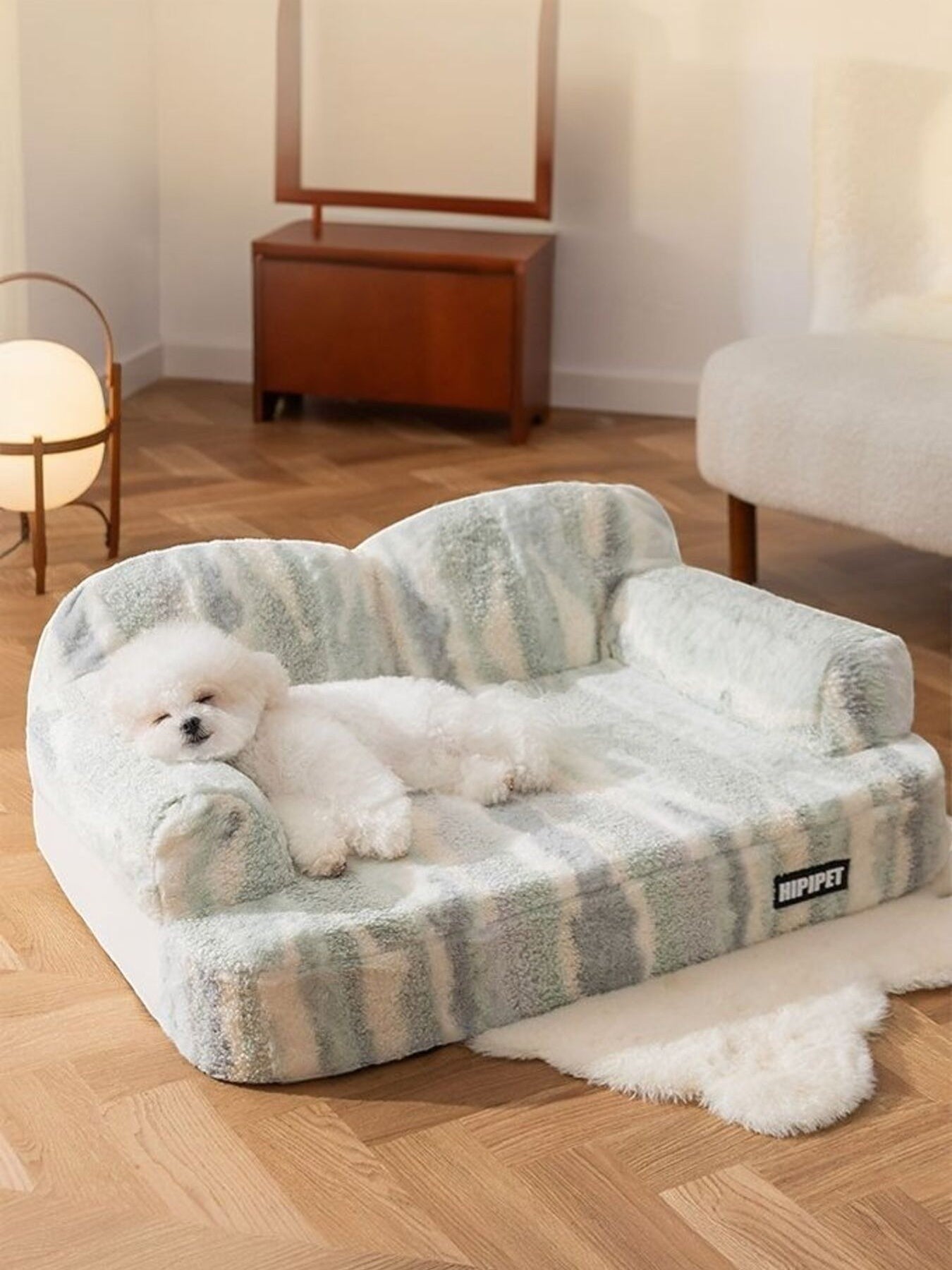 Little Pets Club ultra-soft plush pet sofa bed in a green and white stripe pattern, featuring a white Bichon Frise dog resting.