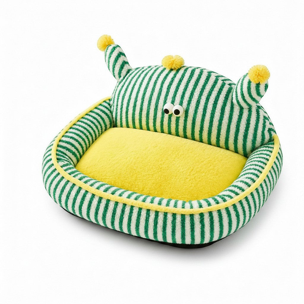 Little Pets Club green and white striped plush pet bed with yellow interior and raised bolster edges, featuring googly eyes and pom-pom antennae.